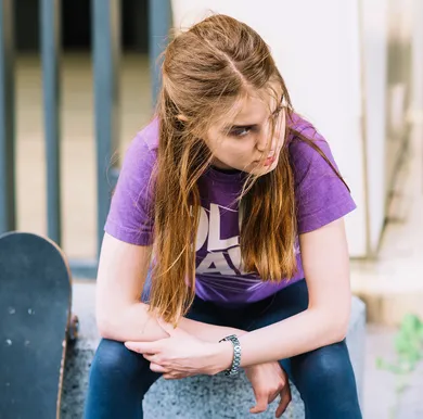 Teen with combined type ADHD showing resilience and confidence in school hallway