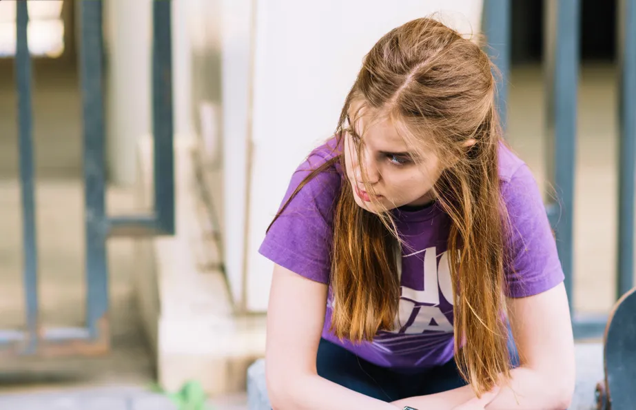 Teen with combined type ADHD showing resilience and confidence in school hallway