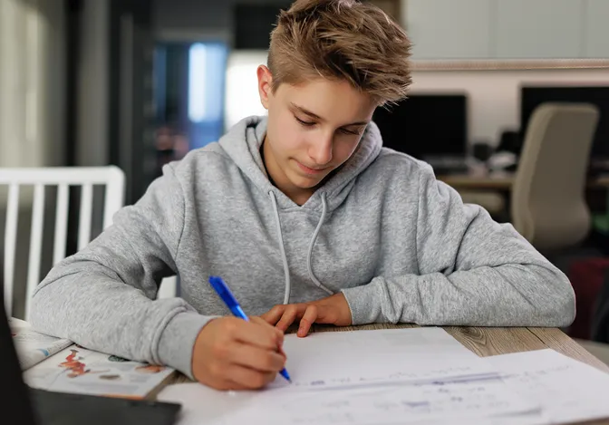 Teen with inattentive ADHD taking organized notes using structured study strategies