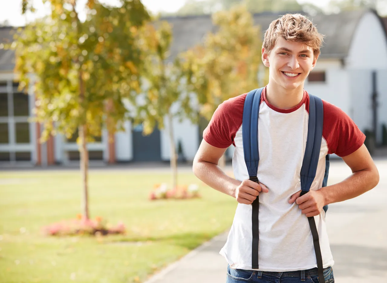 Confident teen student with improved organizational skills and time management after executive function coaching