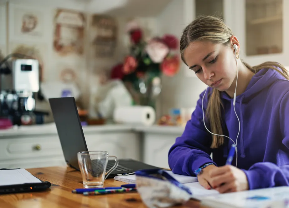 Teen student improving focus and organization skills while doing homework with executive function coaching support