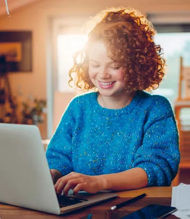 Teen working on laptop after receiving professional ADHD screening assessment and support