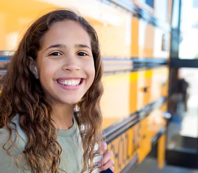 Happy teen with backpack ready for school success after learning executive functioning and study skills through coaching
